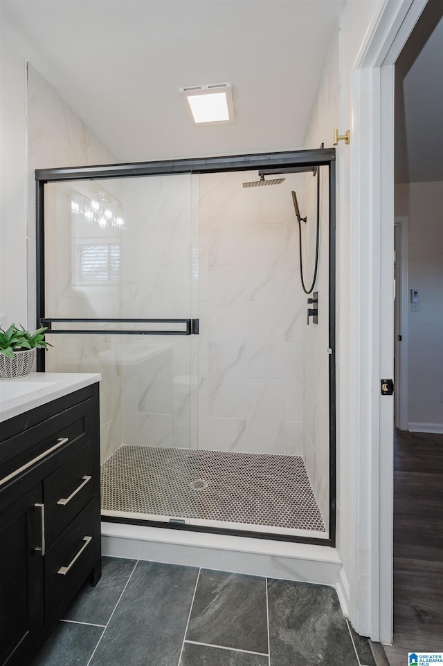 bathroom featuring an enclosed shower, vanity, and tile patterned flooring