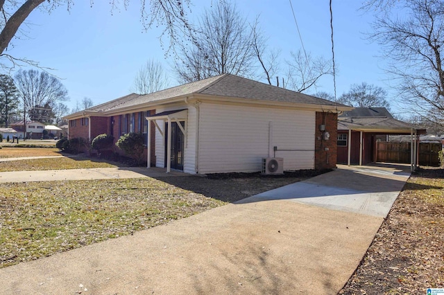 view of side of property with ac unit and a carport