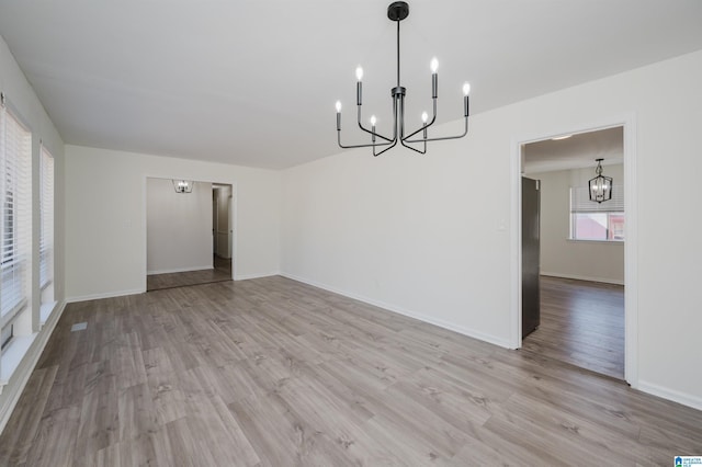 interior space featuring a chandelier and light hardwood / wood-style floors