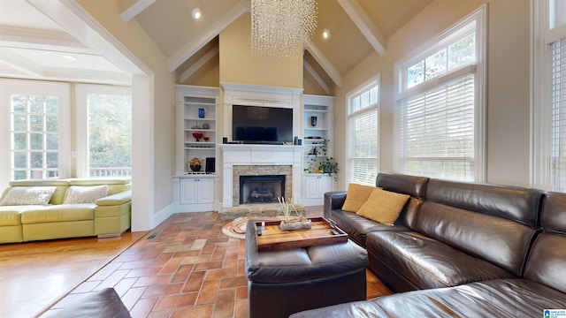 living room with a fireplace, vaulted ceiling, and an inviting chandelier