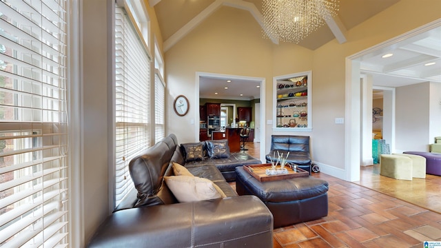 living room featuring a chandelier and beam ceiling