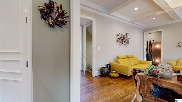 living room with beamed ceiling, light hardwood / wood-style floors, coffered ceiling, and ornamental molding