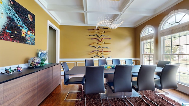 dining room featuring coffered ceiling, crown molding, dark hardwood / wood-style floors, a notable chandelier, and beam ceiling