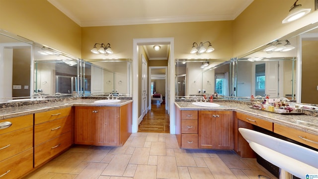 bathroom with tile patterned flooring, vanity, and crown molding