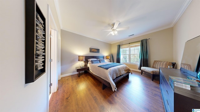 bedroom with dark hardwood / wood-style floors, ceiling fan, and ornamental molding