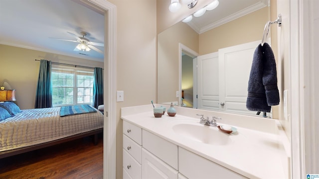 bathroom with vanity, crown molding, hardwood / wood-style floors, and ceiling fan