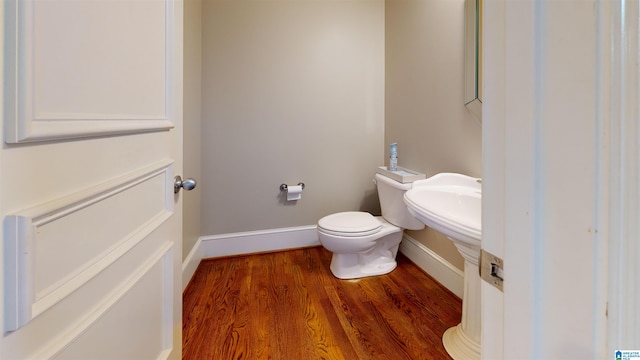 bathroom featuring hardwood / wood-style floors and toilet