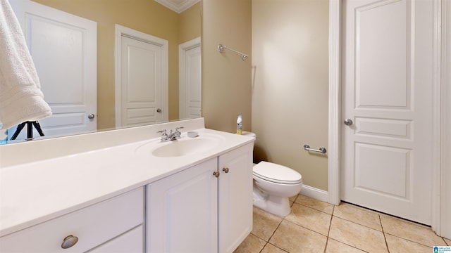 bathroom featuring toilet, vanity, tile patterned floors, and crown molding