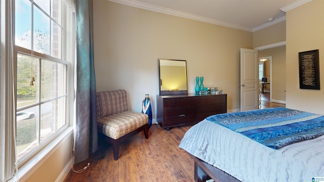 bedroom with multiple windows, wood-type flooring, and ornamental molding