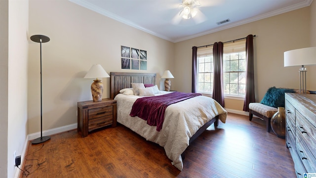 bedroom featuring dark hardwood / wood-style flooring, ceiling fan, and ornamental molding