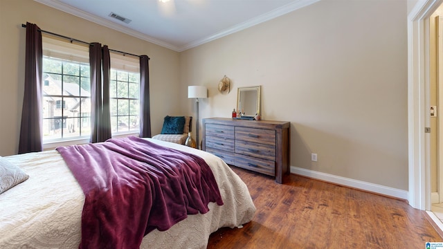 bedroom featuring ornamental molding and hardwood / wood-style flooring