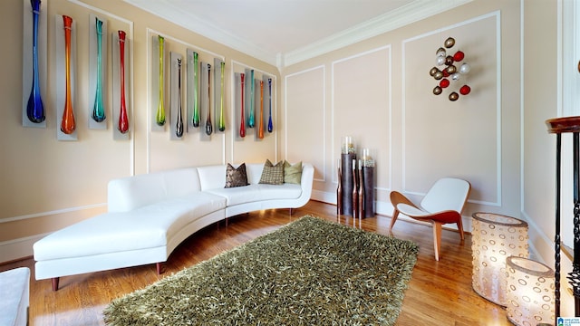 living room with hardwood / wood-style flooring and crown molding