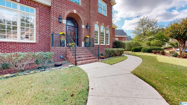 property entrance with a lawn