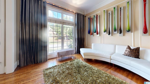 living room featuring wood-type flooring and ornamental molding