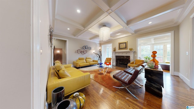 living room with beam ceiling, coffered ceiling, a premium fireplace, wood-type flooring, and ornamental molding