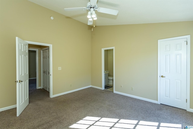 unfurnished bedroom with ceiling fan, connected bathroom, light carpet, and vaulted ceiling