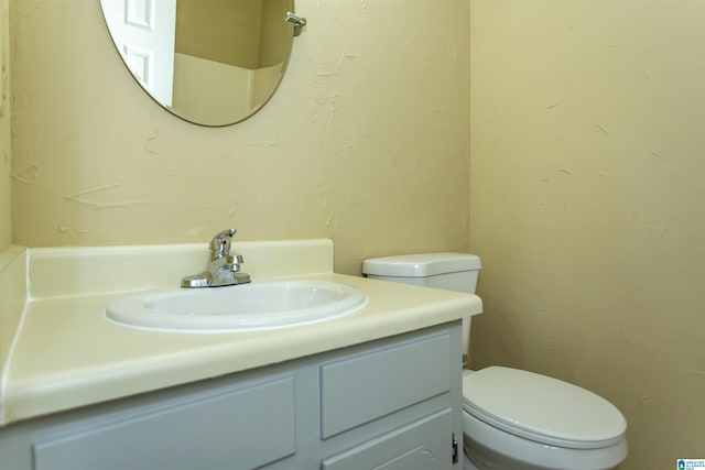 bathroom with toilet and vanity