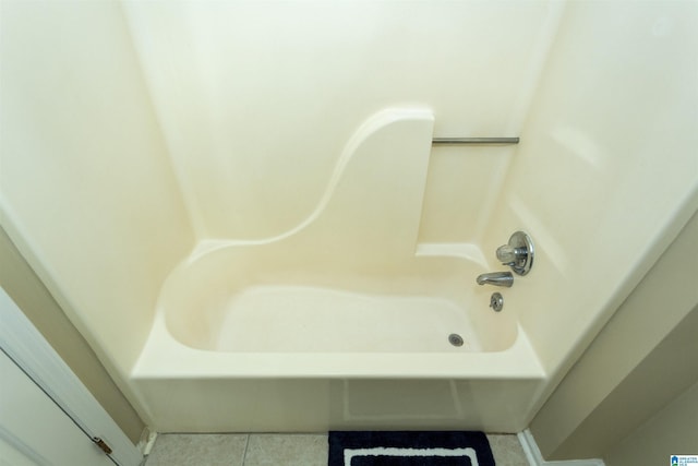 bathroom with tile patterned flooring and a washtub