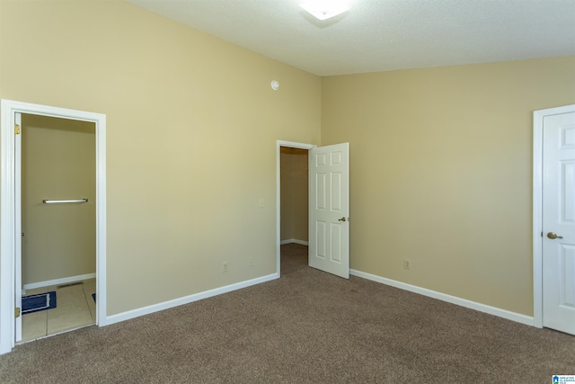 unfurnished bedroom with carpet and a closet