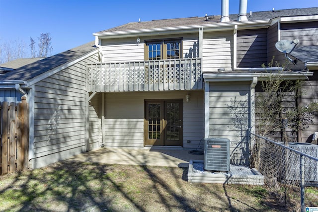 back of property featuring a patio area, cooling unit, french doors, and a balcony