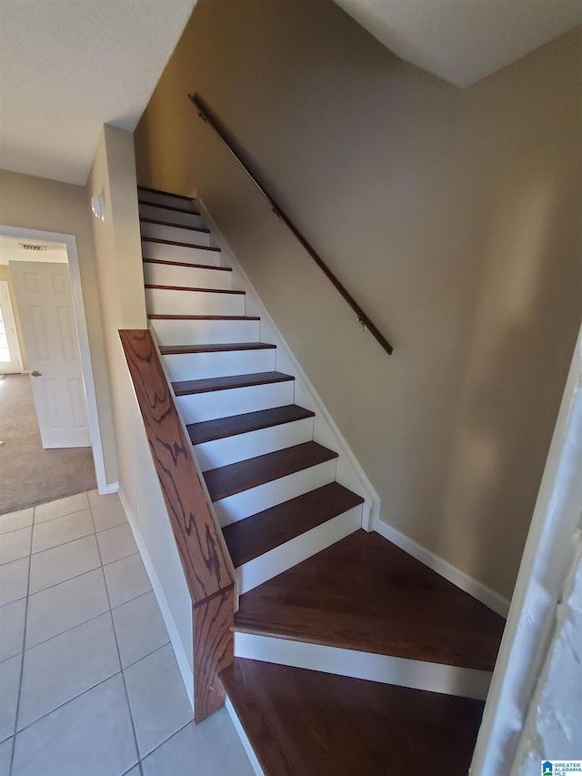 staircase featuring tile patterned flooring