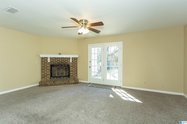 unfurnished living room with ceiling fan, carpet, and a fireplace