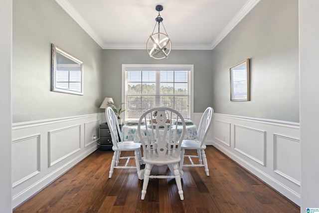 dining space featuring ornamental molding, dark wood-type flooring, and an inviting chandelier