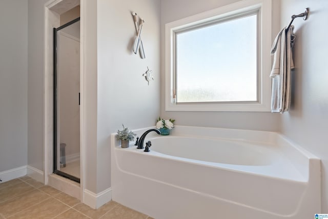 bathroom featuring tile patterned flooring and independent shower and bath