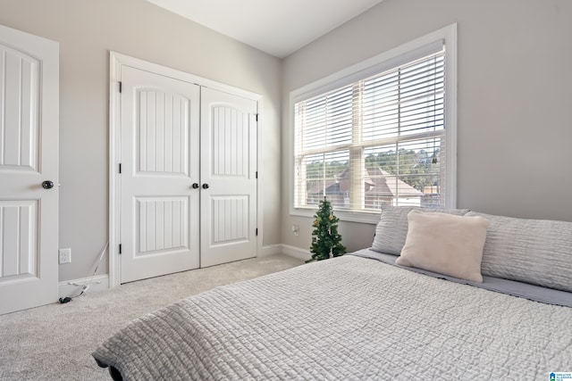 carpeted bedroom with a closet