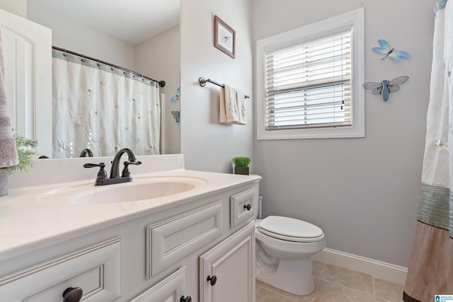 bathroom with tile patterned flooring, vanity, curtained shower, and toilet