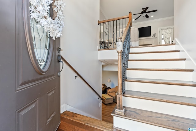 foyer with ceiling fan, hardwood / wood-style floors, and ornamental molding