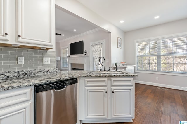 kitchen with dishwasher, light stone countertops, white cabinetry, and sink