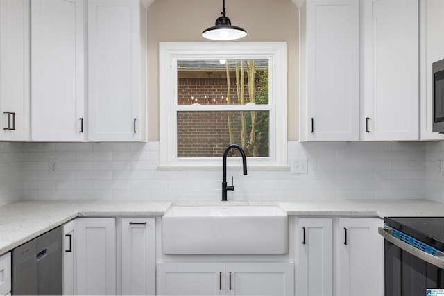 kitchen featuring decorative light fixtures, white cabinetry, tasteful backsplash, and sink