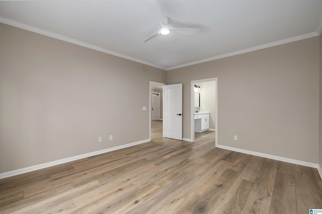 unfurnished bedroom featuring ceiling fan, crown molding, light wood-type flooring, and ensuite bathroom