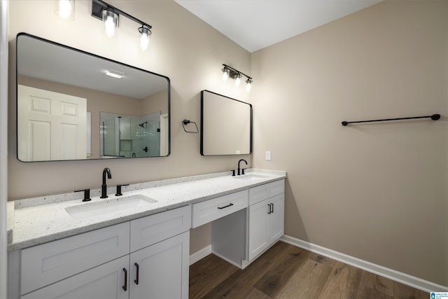 bathroom with wood-type flooring, vanity, and an enclosed shower