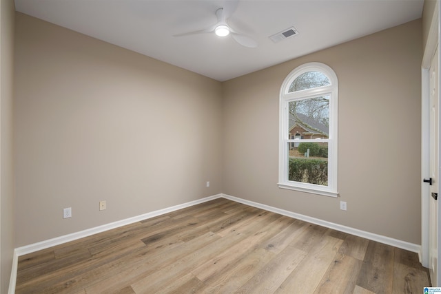 unfurnished room with ceiling fan and light wood-type flooring