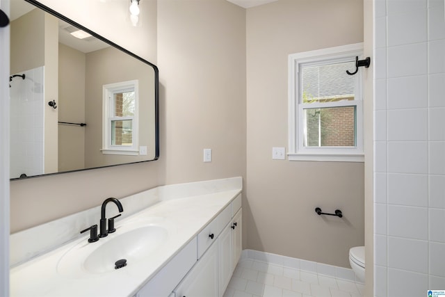 bathroom with tile patterned flooring, vanity, and toilet