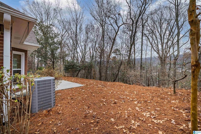 view of yard with cooling unit and a patio