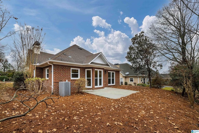 back of property with a patio and central AC