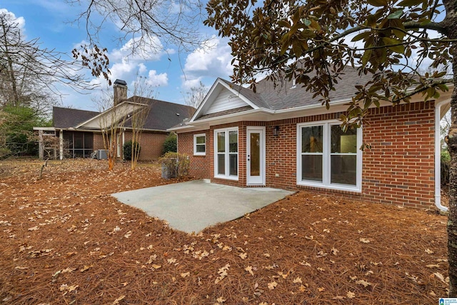 rear view of house with a patio and central AC unit