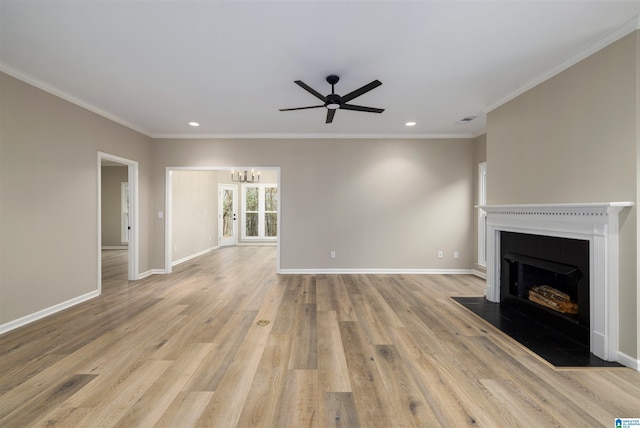 unfurnished living room with ceiling fan with notable chandelier, light hardwood / wood-style floors, and crown molding