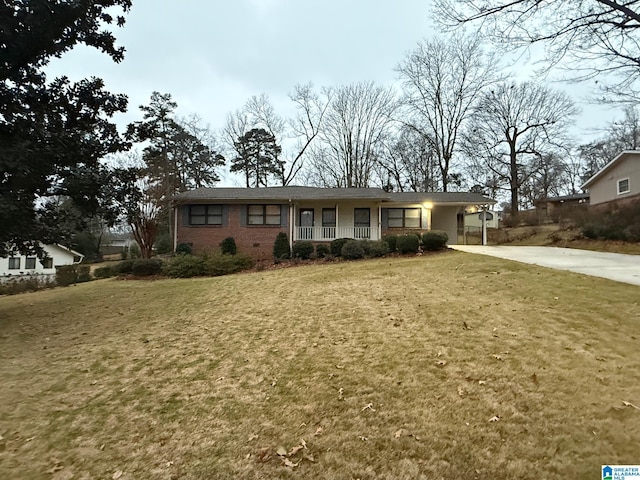 ranch-style home with a front yard and a carport