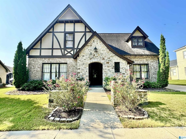 english style home featuring a front yard