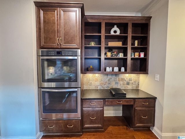 kitchen featuring dark brown cabinets, decorative backsplash, and stainless steel double oven