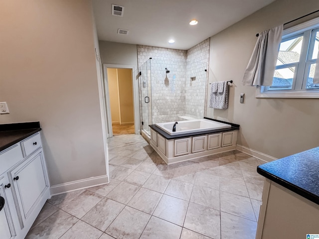 bathroom with tile patterned flooring, vanity, and independent shower and bath