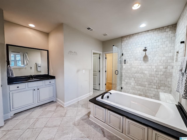 bathroom with tile patterned flooring, vanity, and shower with separate bathtub