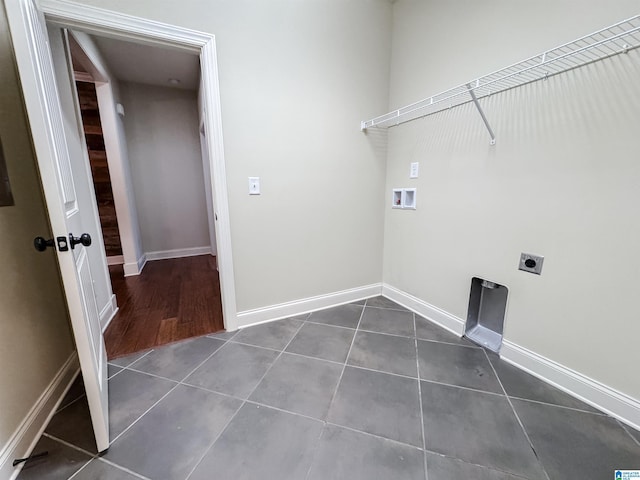 laundry area with hookup for a washing machine, dark tile patterned flooring, and electric dryer hookup