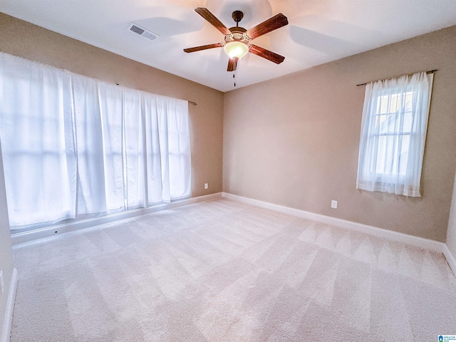 unfurnished room with ceiling fan and light carpet