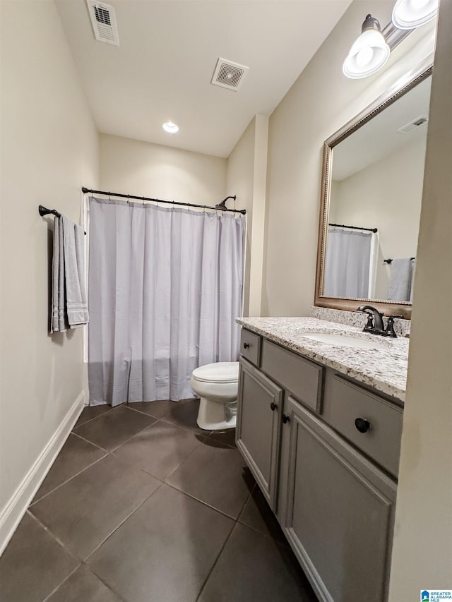 bathroom featuring tile patterned flooring, vanity, curtained shower, and toilet