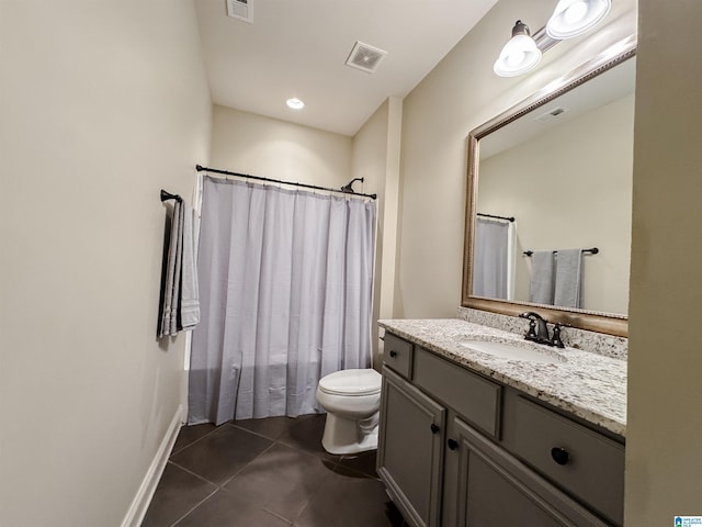 bathroom with tile patterned flooring, vanity, and toilet